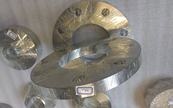 Titanium flanges laid out on the workshop floor